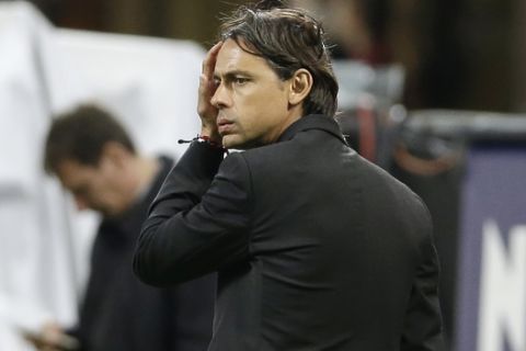 AC Milan coach Filippo Inzaghi touches his forehead during the Serie A soccer match between AC Milan and Genoa at the San Siro stadium in Milan, Italy, Wednesday, April 29, 2015. (AP Photo/Antonio Calanni)