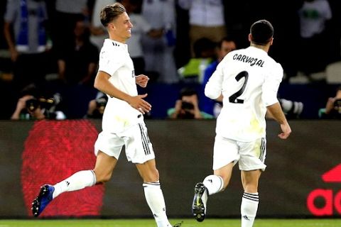 Real Madrid's Marcos Llorente, left, celebrates after scoring his side's second goal during the Club World Cup final soccer match between Real Madrid and Al Ain at Zayed Sport City in Abu Dhabi, United Arab Emirates, Saturday, Dec. 22, 2018. (AP Photo/Kamran Jebreili)