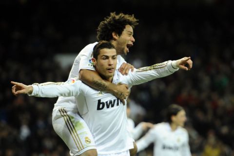 Real Madrid's Portuguese forward Cristiano Ronaldo (front) celebrates with Real Madrid's Brazilian defender Marcelo after scoring during the Spanish league football match Real Madrid vs Zaragoza on January 28, 2012 at the Santiago Bernabeu stadium in Madrid. AFP PHOTO / PIERRE-PHILIPPE MARCOU (Photo credit should read PIERRE-PHILIPPE MARCOU/AFP/Getty Images)