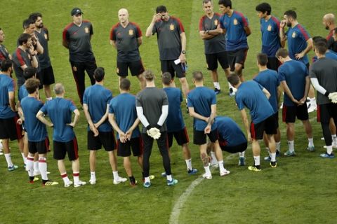 Spain head coach Fernando Hierro, top centre, touches his forehead as gives instructions to his players during Spain's official training on the eve of the group B match between Portugal and Spain at the 2018 soccer World Cup in the Fisht Stadium in Sochi, Russia, Thursday, June 14, 2018. (AP Photo/Francisco Seco)