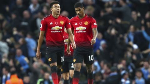 Manchester United's Jesse Lingard, left, and Manchester United's Marcus Rashford react during the English Premier League soccer match between Manchester City and Manchester United at the Etihad stadium in Manchester, England, Sunday, Nov. 11, 2018. (AP Photo/Dave Thompson)
