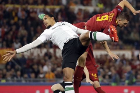 Liverpool's Virgil Van Dijk jumps for the ball with Roma's Edin Dzeko, right, during the Champions League semifinal second leg soccer match between Roma and Liverpool at the Olympic Stadium in Rome, Wednesday, May 2, 2018. (AP Photo/Alessandra Tarantino)