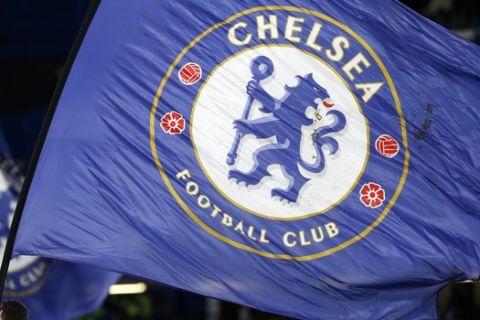 Flags of Chelsea FC are waved on the pitch before the English Premier League soccer match between Chelsea and Manchester City at the Stamford Bridge stadium in London, Wednesday, April 5, 2017. (AP Photo/Alastair Grant)