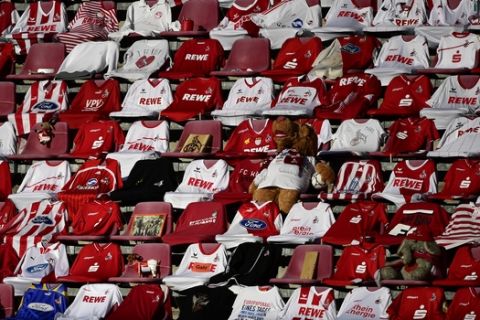 Jerseys of Cologne's supporters are placed on the seats during the German Bundesliga soccer match between 1. FC Cologn and RB Leipzig, in Cologne, Germany, Monday, June 1, 2020. Because of the coronavirus outbreak all soccer matches of the German Bundesliga take place without spectators. (Ina Fassbender/Pool via AP)