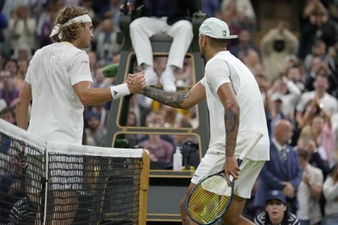 Australia's Nick Kyrgios shakes hands at the net with Greece's Stefanos Tsitsipas after winning their third round men's singles match on day six of the Wimbledon tennis championships in London, Saturday, July 2, 2022. (AP Photo/Kirsty Wigglesworth)