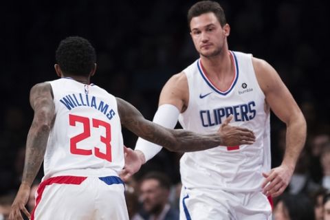 Los Angeles Clippers guard Lou Williams (23) and forward Danilo Gallinari react after Gallinari scored during the second half of an NBA basketball game against the Brooklyn Nets, Saturday, Nov. 17, 2018, in New York. The Clippers won 127-119. (AP Photo/Mary Altaffer)