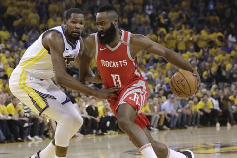 Houston Rockets guard James Harden (13) drives past Golden State Warriors forward Kevin Durant during the first half of Game 6 of the NBA basketball Western Conference Finals in Oakland, Calif., Saturday, May 26, 2018. (AP Photo/Marcio Jose Sanchez)