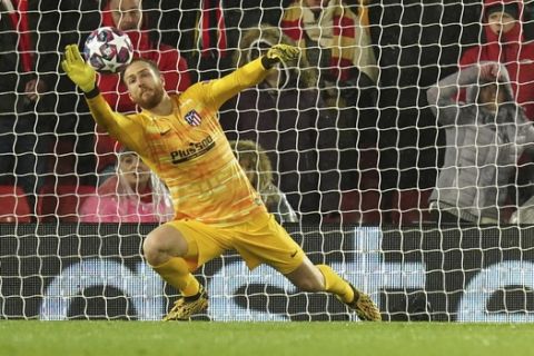 Atletico Madrid's goalkeeper Jan Oblak makes a save against Liverpool's Roberto Firmino during a second leg, round of 16, Champions League soccer match between Liverpool and Atletico Madrid at Anfield stadium in Liverpool, England, Wednesday, March 11, 2020. (AP Photo/Jon Super)
