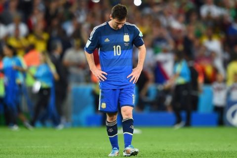 RIO DE JANEIRO, BRAZIL - JULY 13: A dejected Lionel Messi of Argentina reacts after being defeated by Germany 1-0 in extra time during the 2014 FIFA World Cup Brazil Final match between Germany and Argentina at Maracana on July 13, 2014 in Rio de Janeiro, Brazil.  (Photo by Matthias Hangst/Getty Images)
