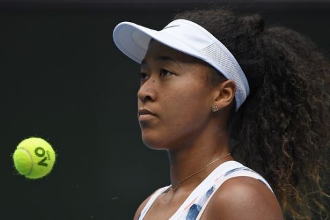 Japan's Naomi Osaka waits to serve to China's Zheng Saisai during their second round singles match at the Australian Open tennis championship in Melbourne, Australia, Wednesday, Jan. 22, 2020. (AP Photo/Andy Brownbill)