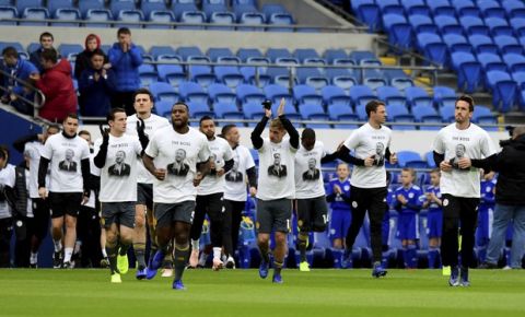 Leicester City players warm-up wearing Vichai Srivaddhanaprabha shirts that read 'The Boss' during the warm-up before kick-off of the English Premier League soccer match between Cardiff City and Leicester City at the Cardiff City Stadium, Cardiff. Wales. Saturday Nov. 3, 2018. (Simon Galloway/PA via AP)