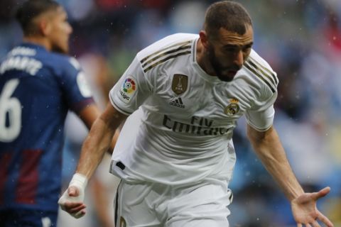 Real Madrid's Karim Benzema celebrates after scoring his side's first goal during the Spanish La Liga soccer match between Real Madrid and Levante at the Santiago Bernabeu stadium in Madrid, Spain, Saturday, Sept. 14, 2019. (AP Photo/Bernat Armangue)