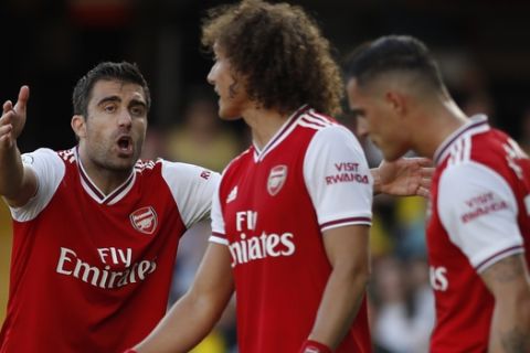 Arsenal's Sokratis Papastathopoulos, center, gestures as he shouts at his teammates during their English Premier League soccer match between Watford and Arsenal at the Vicarage Road stadium in Watford near London, Sunday, Sept. 15, 2019. (AP Photo/Alastair Grant)