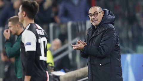 Juventus' head coach Maurizio Sarri, right, claps hands for Juventus' Paulo Dybala, left, after scoring during the Champions League group D soccer match between Juventus and Atletico Madrid at the Allianz stadium in Turin, Italy, Tuesday, Nov. 26, 2019. (AP Photo/Antonio Calanni)