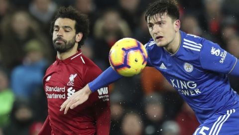 Leicester City defender Harry Maguire right, challenges for the ball with Liverpool forward Mohamed Salah, during the English Premier League soccer match between Liverpool and Leicester City, at Anfield Stadium, Liverpool, England, Wednesday, Jan.29, 2019. (AP Photo/Jon Super)