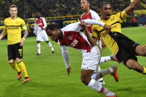 Dortmund's Abdou Diallo, right, fights for the ball with Monaco forwarder Samuel Grandsir during the Champions League group A soccer match between Borussia Dortmund and AS Monaco in Dortmund, Germany, Wednesday, Oct. 3, 2018. (AP Photo/Martin Meissner)