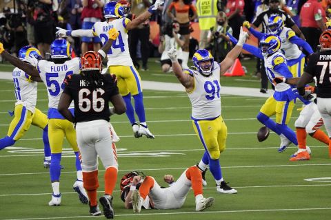 Los Angeles Rams nose tackle Greg Gaines (91) celebrates the tackle of Cincinnati Bengals quarterback Joe Burrow (9) during the second half of the NFL Super Bowl 56 football game Sunday, Feb. 13, 2022, in Inglewood, Calif. The Los Angeles Rams won 23-20.(AP Photo/Ted S. Warren)