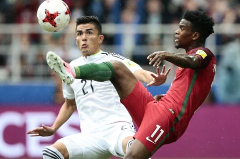 Portugal's Nelson Semedo, right, and Mexico's Luis Reyes go for the ball during the Confederations Cup, third place soccer match between Portugal and Mexico, at the Moscow Spartak Stadium, Sunday, July 2, 2017. (AP Photo/Denis Tyrin)