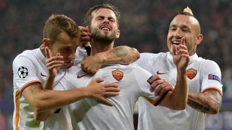 Roma's Miralem Pjanic, center, celebrates with his teammates, right, Radja Nainggolan and Lucas Digne after scoring during the Champions League group E soccer match between Bayer Leverkusen and AS Roma in Leverkusen, Germany, Tuesday, Oct. 20, 2015. (ANSA/AP Photo/Martin Meissner)