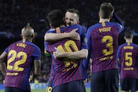 Barcelona's Lionel Messi, centre, is hugged by Jordi Alba after scoring his side's third goal during the Champions League round of 16, 2nd leg, soccer match between FC Barcelona and Olympique Lyon at the Camp Nou stadium in Barcelona, Spain, Wednesday, March 13, 2019. (AP Photo/Emilio Morenatti)