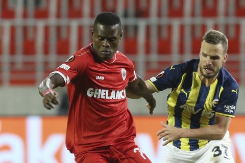 Royal Antwerp's Mbwana Samatta is challenged by Fenerbahce's Filip Novak during the group D Europa League soccer match between Royal Antwerp and Fenerbahce, at the Bosuil Stadium in Antwerp, Belgium, Thursday, Nov. 4, 2021. (AP Photo/Francois Walschaerts)