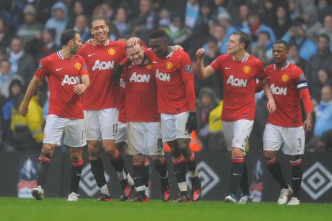 Manchester United's English forward Wayne Rooney (C) celebrates with team-mates (L-R) Welsh midfielder Ryan Giggs, English defender Chris Smalling, English forward Danny Welbeck, English defender Phil Jones and French defender Patrice Evra, after scoring the third goal during the FA Cup third round football match between Manchester City and Manchester United at The Etihad stadium in Manchester, north-west England, on January 8, 2012.  AFP PHOTO / ANDREW YATES

RESTRICTED TO EDITORIAL USE. No use with unauthorized audio, video, data, fixture lists, club/league logos or live services. Online in-match use limited to 45 images, no video emulation. No use in betting, games or single club/league/player publications. (Photo credit should read ANDREW YATES/AFP/Getty Images)
