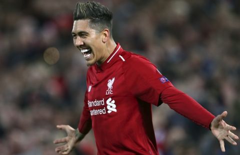 Liverpool's Roberto Firmino celebrates after scoring his side's second goal during the Champions League quarterfinal, first leg, soccer match between Liverpool and FC Porto at Anfield Stadium, Liverpool, England, Tuesday April 9, 2019. (AP Photo/Dave Thompson)