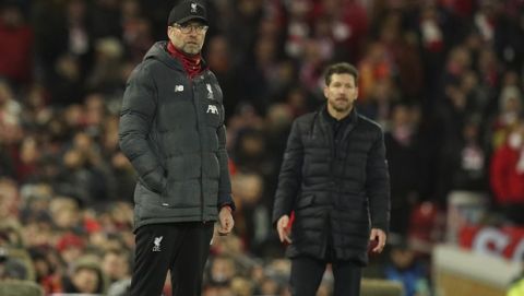Liverpool's manager Jurgen Klopp, left, and Atletico Madrid's head coach Diego Simone, right, stand on the touchline during a second leg, round of 16, Champions League soccer match between Liverpool and Atletico Madrid at Anfield stadium in Liverpool, England, Wednesday, March 11, 2020. (AP Photo/Jon Super)