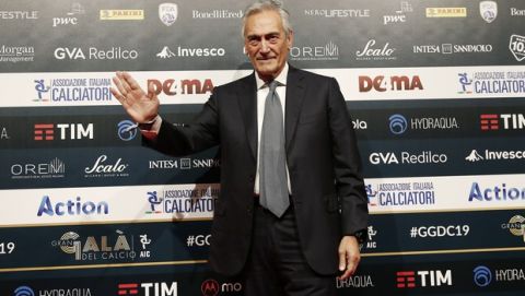 FIGC President Gabriele Gravina poses for photographer as he arrives for the Gran Gala' soccer awards ceremony, in Milan, Italy, Monday, Dec. 2, 2019. (AP Photo/Antonio Calanni)