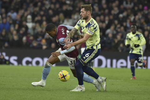 Leeds United's Liam Cooper, right, vies for the ball with Aston Villa's Leon Bailey during the English Premier League soccer match between Aston Villa and Leeds United at Villa Park in Birmingham, England, Friday, Jan. 13, 2023. (AP Photo/Rui Vieira)