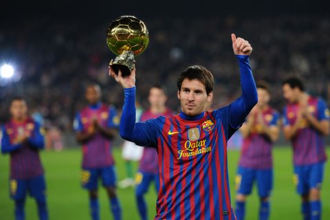 Barcelona's Argentinian forward Lionel Messi shows the Ballon d'Or Trophy before the Spanish league football match between FC Barcelona and Betis at the Camp Nou stadium in Barcelona on January 15, 2012. AFP PHOTO/LLUIS GENE (Photo credit should read LLUIS GENE/AFP/Getty Images)