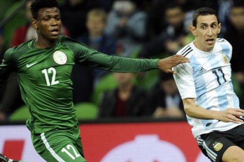 Nigeria's Abdullahi Shehu, left, challenges for the ball with Argentina's Angel Di Maria during the international friendly soccer match between Argentina and Nigeria in Krasnodar, Russia, Tuesday, Nov. 14, 2017. (AP Photo/Sergey Pivovarov)