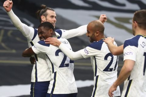 Tottenham's Gareth Bale, left, celebrates with teammates after scoring his side's first goal during an English Premier League soccer match between Tottenham Hotspur and Southampton at the Tottenham Hotspur Stadium in London, England, Wednesday April 21, 2021. (Clive Rose/Pool via AP)