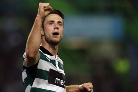 Sporting's Ricky van Wolfswinkel, from The Netherlands, celebrates after scoring the opening goal against Benfica during their Portuguese league soccer match Monday, Dec. 10 2012, at Sporting's Alvalade stadium in Lisbon. (AP Photo/Armando Franca)
