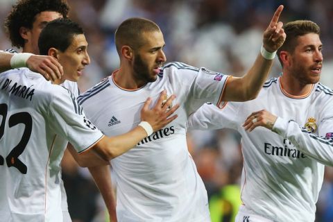 MADRID, SPAIN - APRIL 23:  Karim Benzema of Real Madrid celebrates scoring the opening goal with team mates during the UEFA Champions League semi-final first leg match between Real Madrid and FC Bayern Muenchen at the Estadio Santiago Bernabeu on April 23, 2014 in Madrid, Spain.  (Photo by Martin Rose/Bongarts/Getty Images)