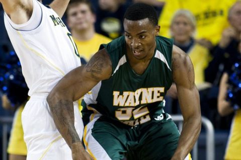 Michigan guard Zack Novak, left, defends Wayne State center Ike Udanoh (32) in the first half of an exhibition NCAA college basketball game, Friday, Nov. 4, 2011, at Crisler Arena in Ann Arbor, Mich. (AP Photo/Tony Ding)