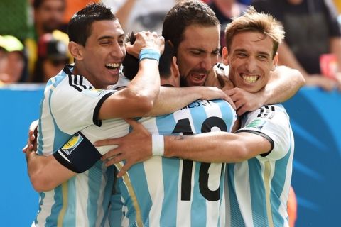 BRASILIA, BRAZIL - JULY 05:  Gonzalo Higuain of Argentina (2nd L) celebrates scoring his team's first goal with Angel di Maria (L), Lionel Messi (2nd L) and Lucas Biglia during the 2014 FIFA World Cup Brazil Quarter Final match between Argentina and Belgium at Estadio Nacional on July 5, 2014 in Brasilia, Brazil.  (Photo by Matthias Hangst/Getty Images)