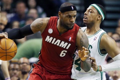 Miami Heat's LeBron James (6) backs down on Boston Celtics' Paul Pierce (34) in the first quarter of an NBA basketball game in Boston, Monday, March 18, 2013. (AP Photo/Michael Dwyer)