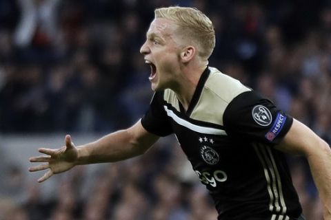 Ajax's Donny van de Beek celebrates after scoring his side's opening goal during the Champions League semifinal first leg soccer match between Tottenham Hotspur and Ajax at the Tottenham Hotspur stadium in London, Tuesday, April 30, 2019. (AP Photo/Kirsty Wigglesworth)