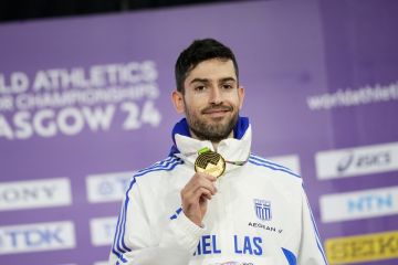 Miltiadis Tentoglou, of Greece, poses on the podium after winning the gold medal in the men's long jump during the World Athletics Indoor Championships at the Emirates Arena in Glasgow, Scotland, Saturday, March 2, 2024. (AP Photo/Bernat Armangue)