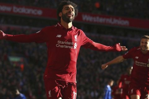 Liverpool's Mohamed Salah celebrates scoring his side's first goal of the game, during the English Premier League soccer match between Liverpool and Cardiff City at Anfield, in Liverpool, England, Saturday, Oct. 27, 2018. (Dave Thompson/PA via AP)