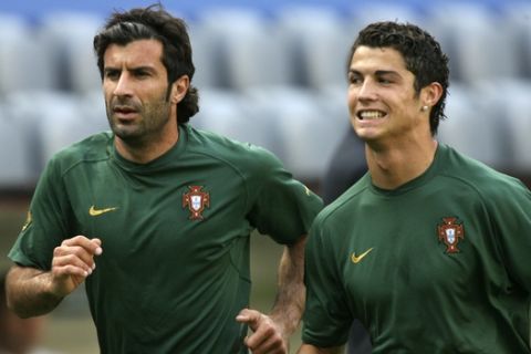 Portugal's Luis Figo, left, and Cristiano Ronaldo, jog during World Cup training at the World Cup stadium, Tuesday, July 4, 2006, in Munich, Germany. Portugal takes on France in a World Cup semifinal match on July 5, at the stadium.   (AP Photo/Dusan Vranic) 