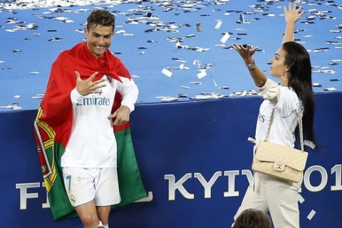 Real Madrid's Cristiano Ronaldo, left, and his girlfriend Georgina Rodriguez celebrate after the Champions League Final soccer match between Real Madrid and Liverpool at the Olimpiyskiy Stadium in Kiev, Ukraine, Saturday, May 26, 2018. Madrid defeated Liverpool by 3-1. (AP Photo/Darko Vojinovic)