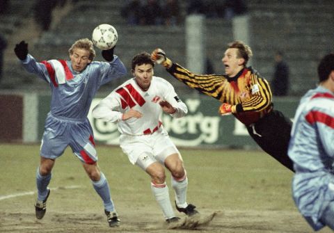 Spartak's goalie Gintaras Stauche, right, punches the ball during the UEFA Champions League match against A.S. Monaco in Moscow, Russia, Wednesday, March 30, 1994. At left is Monaco's Jurgen Klinsmann. Spartak tied with Monaco 0-0 allowing Monaco to advance to the semi-finals. Center man is unidentified. (AP Photo/Alexander Zemlianichenko)