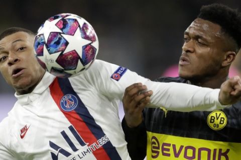 PSG's Kylian Mbappe, left, duels for the ball with Dortmund's Dan-Axel Zagadou during the Champions League round of 16 first leg soccer match between Borussia Dortmund and Paris Saint Germain in Dortmund, Germany, Tuesday, Feb. 18, 2020. (AP Photo/Michael Probst)