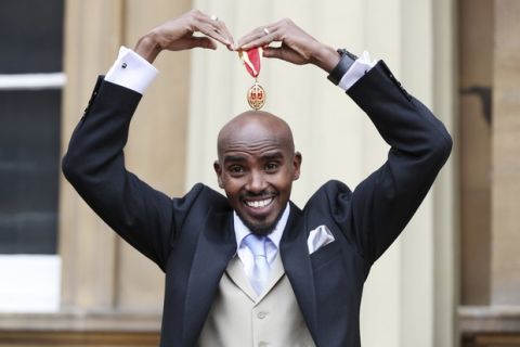 Four-time Olympic gold medalist Mo Farah poses for a photo after he was awarded a Knighthood by Britain's Queen Elizabeth II at an Investiture ceremony at Buckingham Palace in London, Tuesday Nov. 14, 2017.   Farah is the most successful British distance runner track athlete in modern Olympic Games history. (Jonathan Brady/Pool via AP)