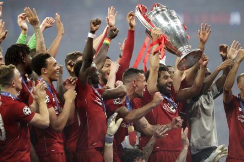Liverpool's players celebrate with the trophy after winning the Champions League final soccer match between Tottenham Hotspur and Liverpool at the Wanda Metropolitano Stadium in Madrid, Sunday, June 2, 2019. Liverpool won 2-0. (AP Photo/Felipe Dana)