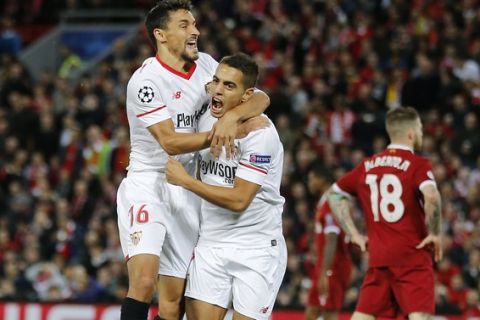 Sevilla's Wissam Ben Yedder, right, celebrates with his teammate Jesus Navas after scoring during the Champions League group E soccer match between Liverpool and Sevilla at Anfield stadium in Liverpool, England, Wednesday, Sept. 13, 2017. (AP Photo/Frank Augstein)