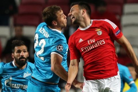 Benficas Andreas Samaris jumps for the ball with Zenit's Artyom Dzyuba during a Champions League Round of 16 first leg soccer match between Benfica and Zenit at Benfica's Luz stadium in Lisbon, Portugal, Tuesday, Feb. 16, 2016. (AP Photo/Armando Franca)
