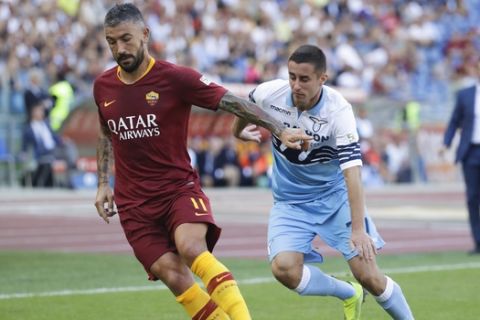 Roma's Aleksandar Kolarov , left, is challenged by Lazio's Adam Marusic during the Serie A soccer match between Roma and Lazio, at the Rome Olympic Stadium, Saturday, Sept. 29, 2018. (AP Photo/Andrew Medichini)